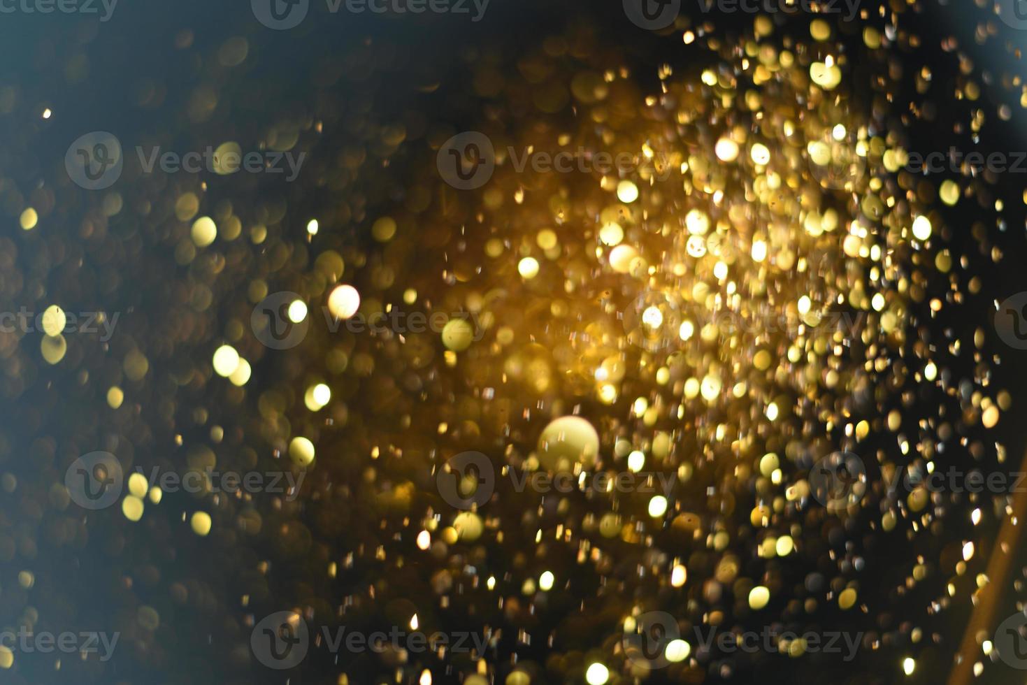 Golden glitter bokeh lighting texture Blurred abstract background for birthday, anniversary, wedding, new year eve or Christmas photo