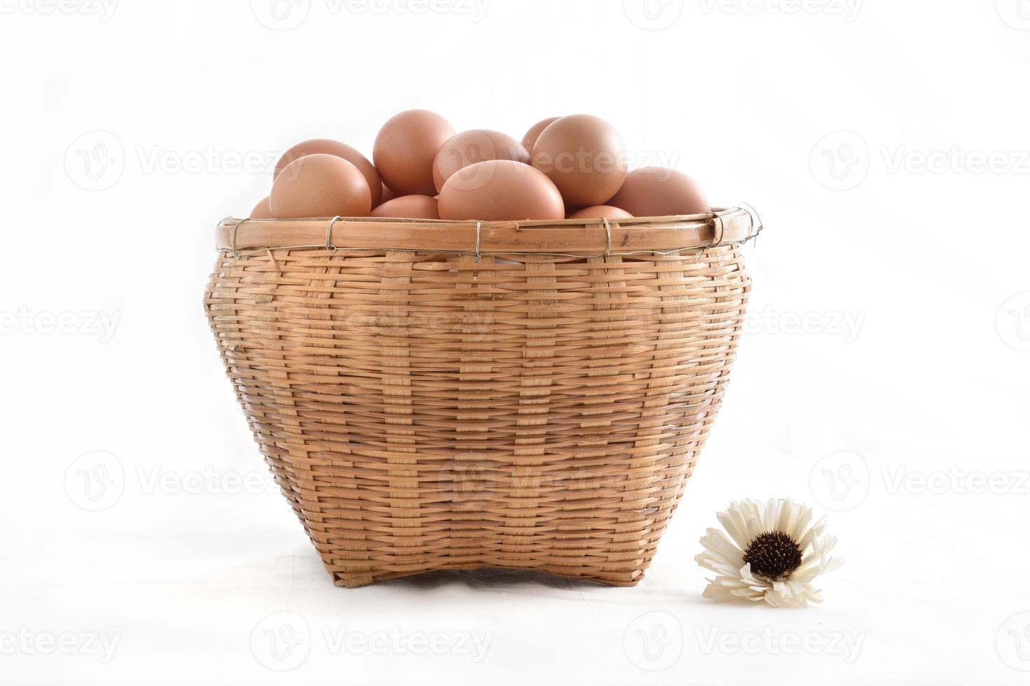eggs in basket filled isolated on white background photo