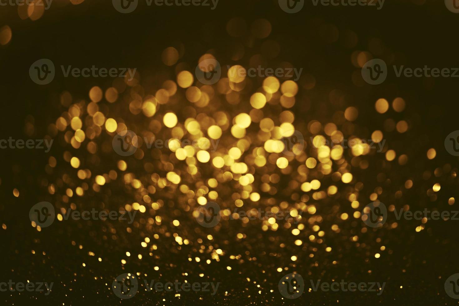 Golden glitter bokeh lighting texture Blurred abstract background for birthday, anniversary, wedding, new year eve or Christmas photo