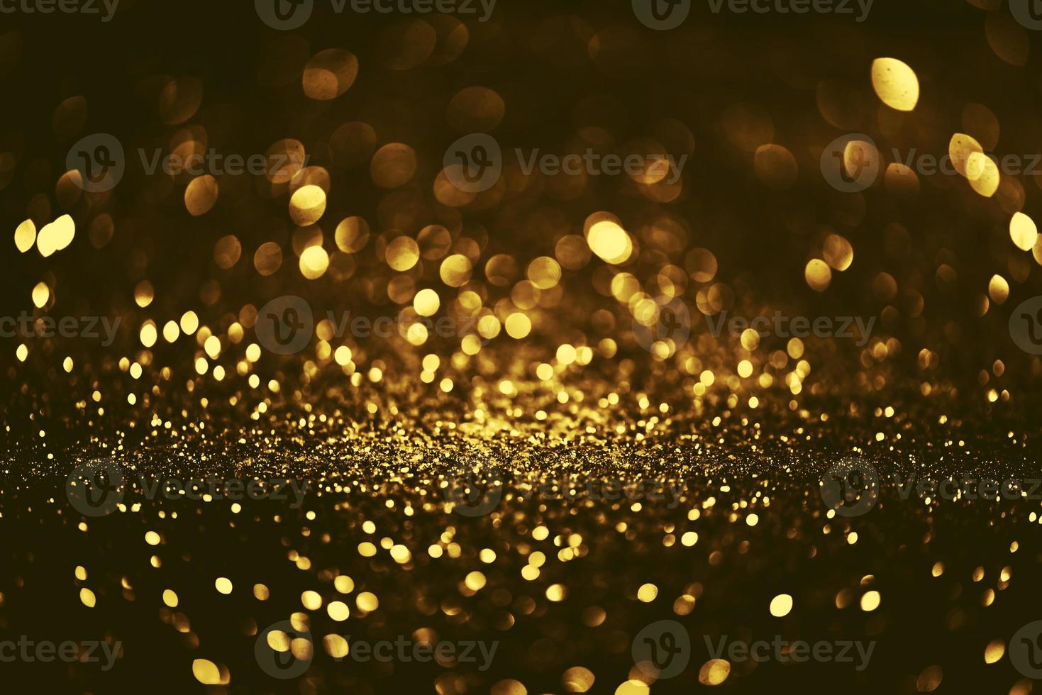 Golden glitter bokeh lighting texture Blurred abstract background for birthday, anniversary, wedding, new year eve or Christmas photo