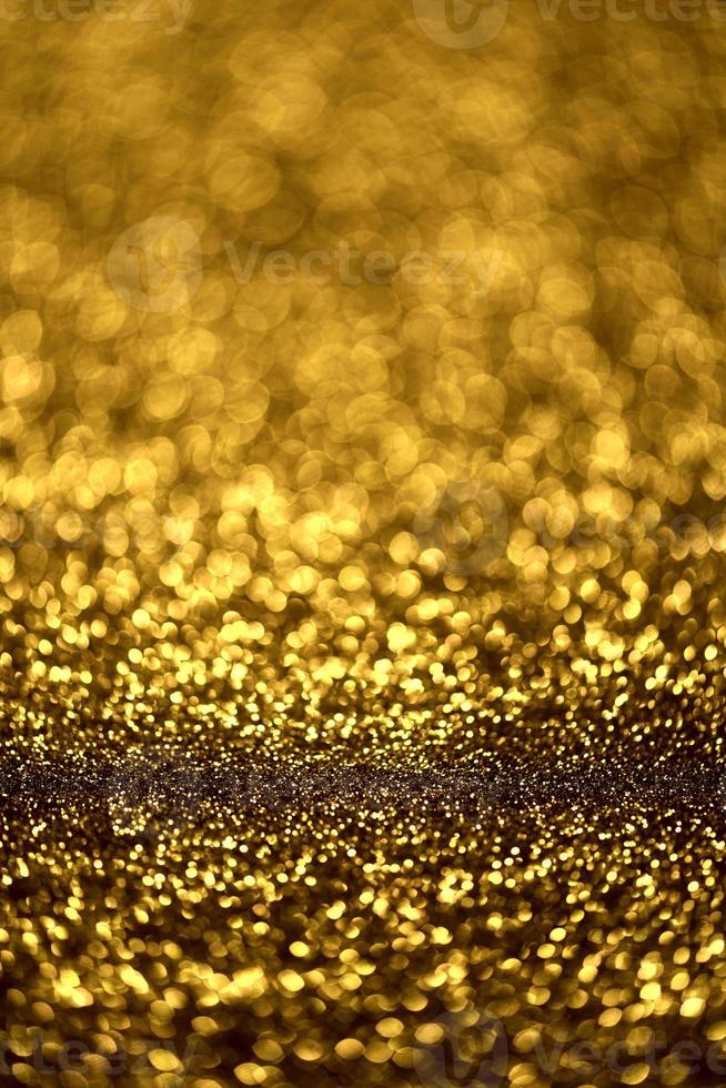 Golden glitter bokeh lighting texture Blurred abstract background for birthday, anniversary, wedding, new year eve or Christmas photo