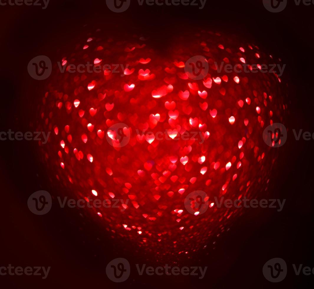 Red Blur heart shape of ligth bokeh on a black background photo