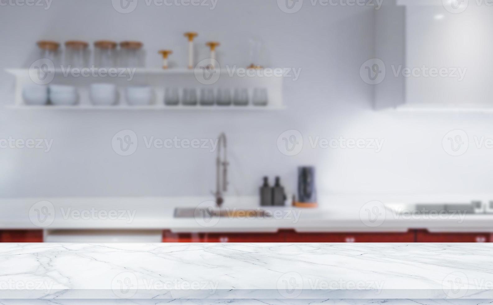 White marble texture table top on blurred kitchen background for montage or display your products photo