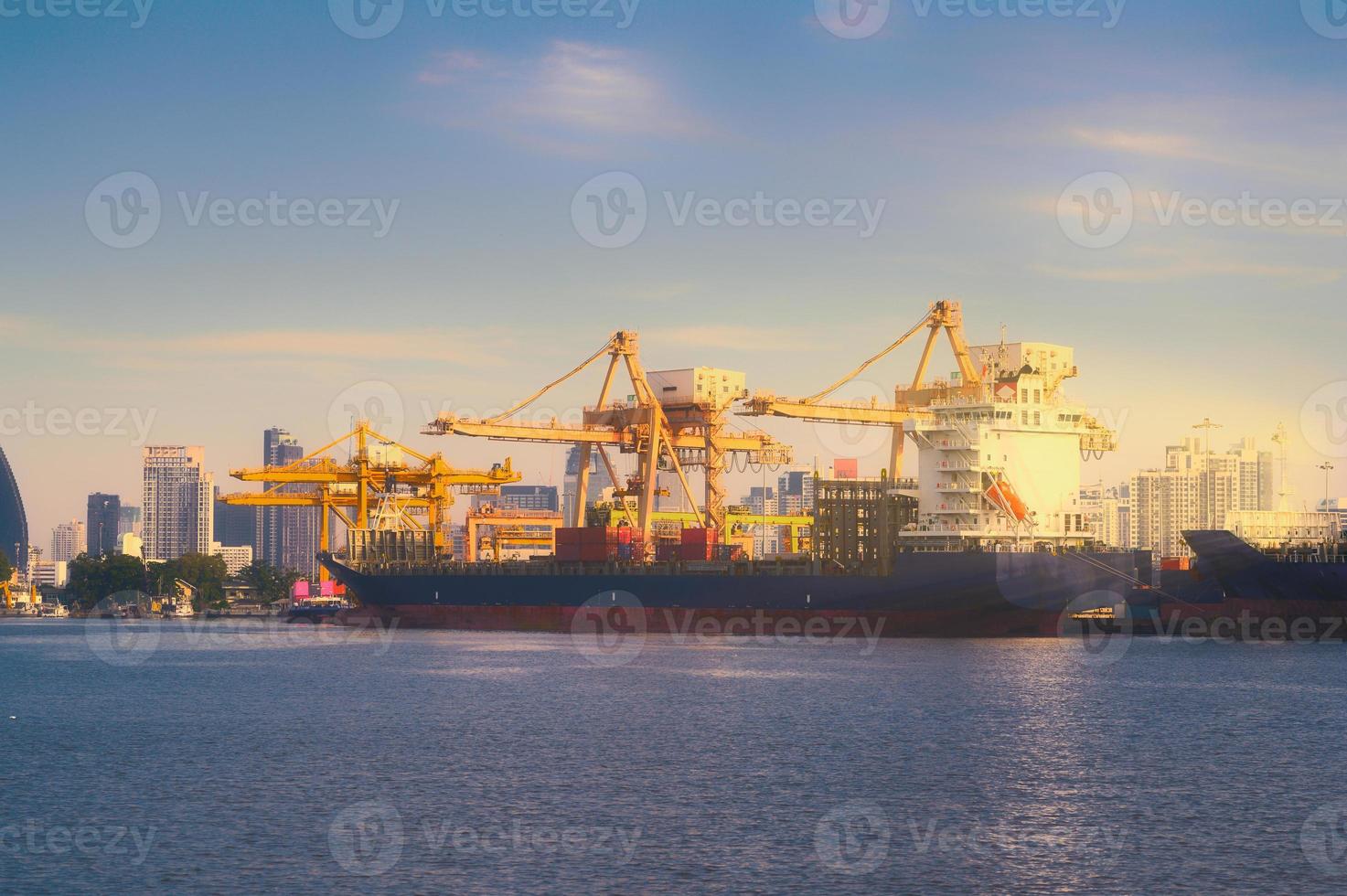 International Container Cargo ship with working crane bridge in shipyard background, logistic import export background and transport industry. photo