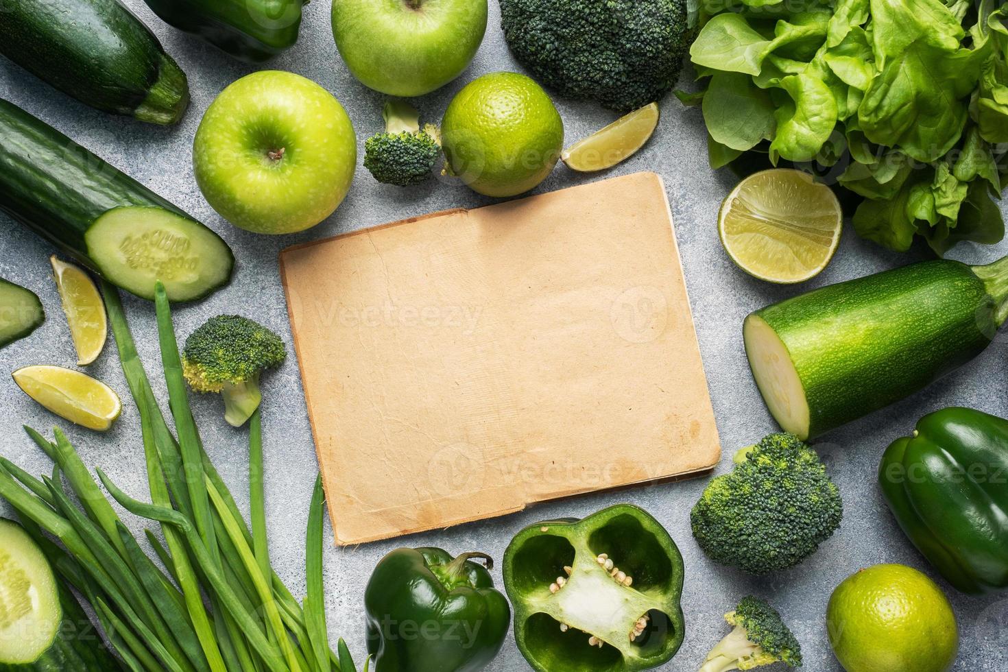 Frame Fresh green vegetables and herbs on a grey concrete background. Copy space. photo