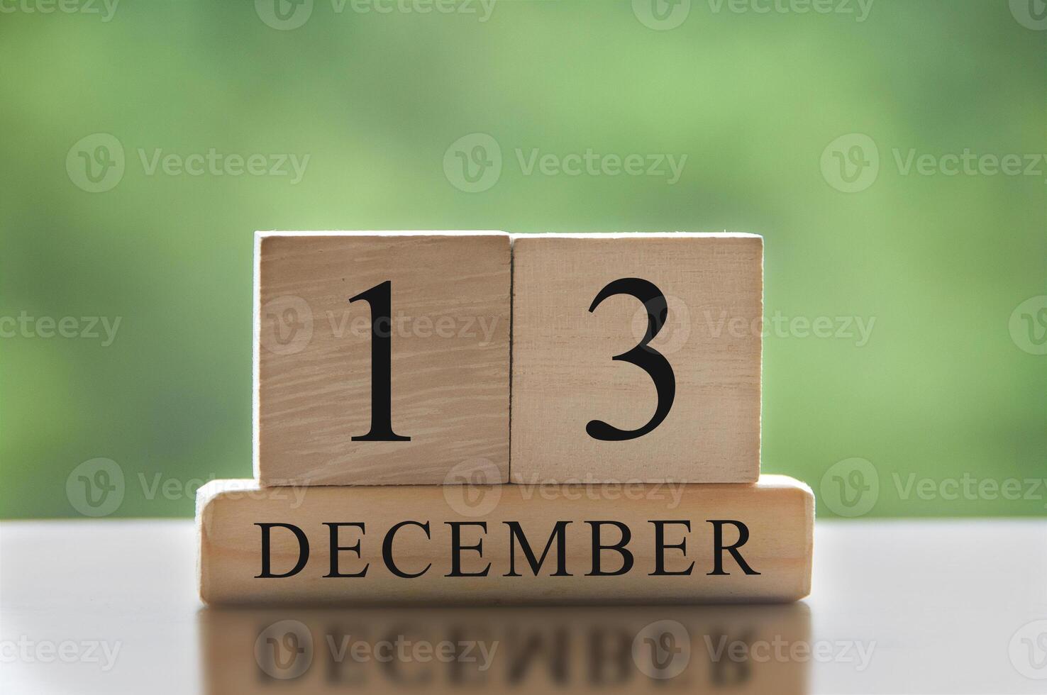 December 13 text on wooden blocks with blurred nature background. Calendar concept photo