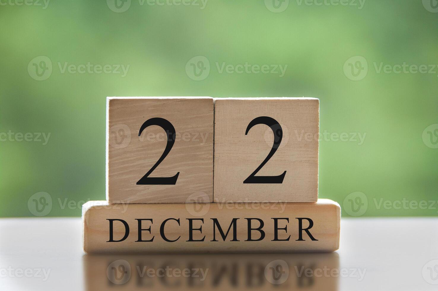 December 21 text on wooden blocks with blurred nature background. Calendar concept. photo