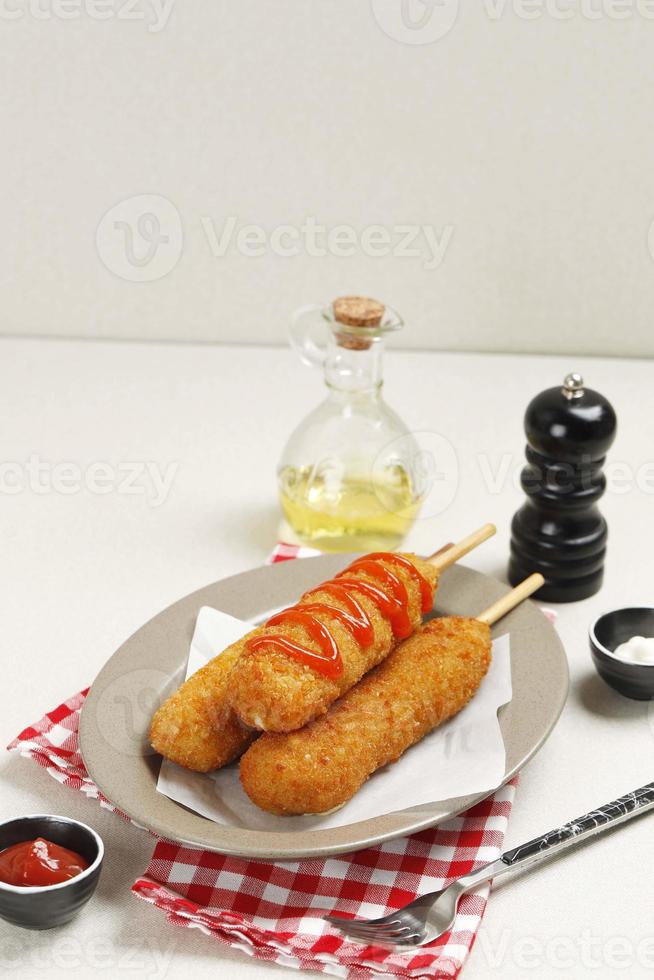 Three Corndog with Tomato Sauce Topping, Popular Korean Street Food. photo