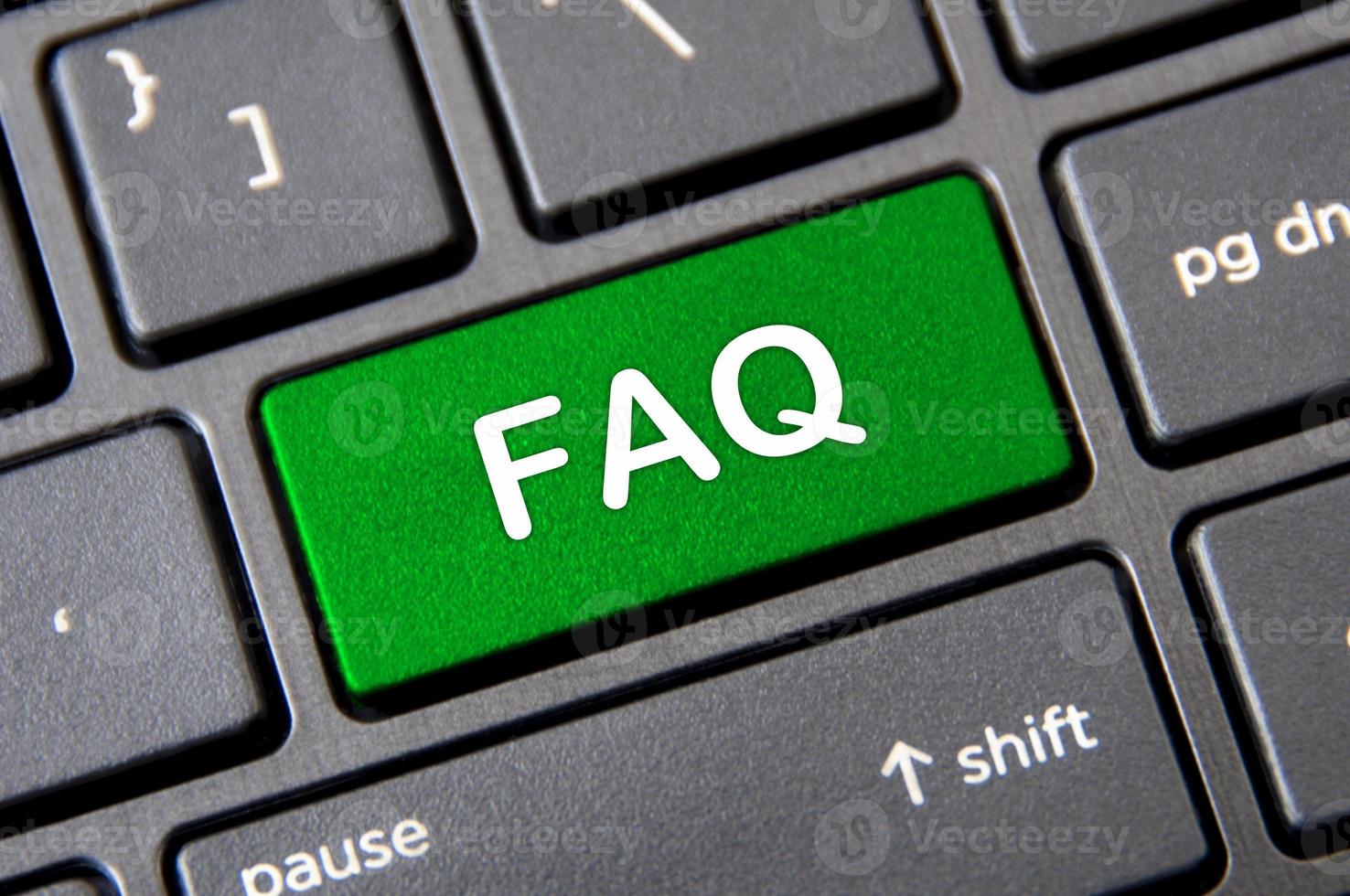 Frequently ask question concept - Laptop keyboard with green FAQ button. photo