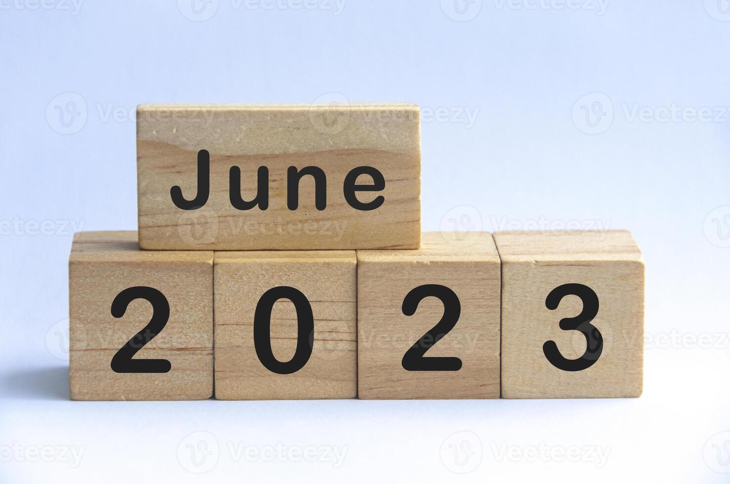 June 2023 text on wooden blocks with white color background. Copy space photo