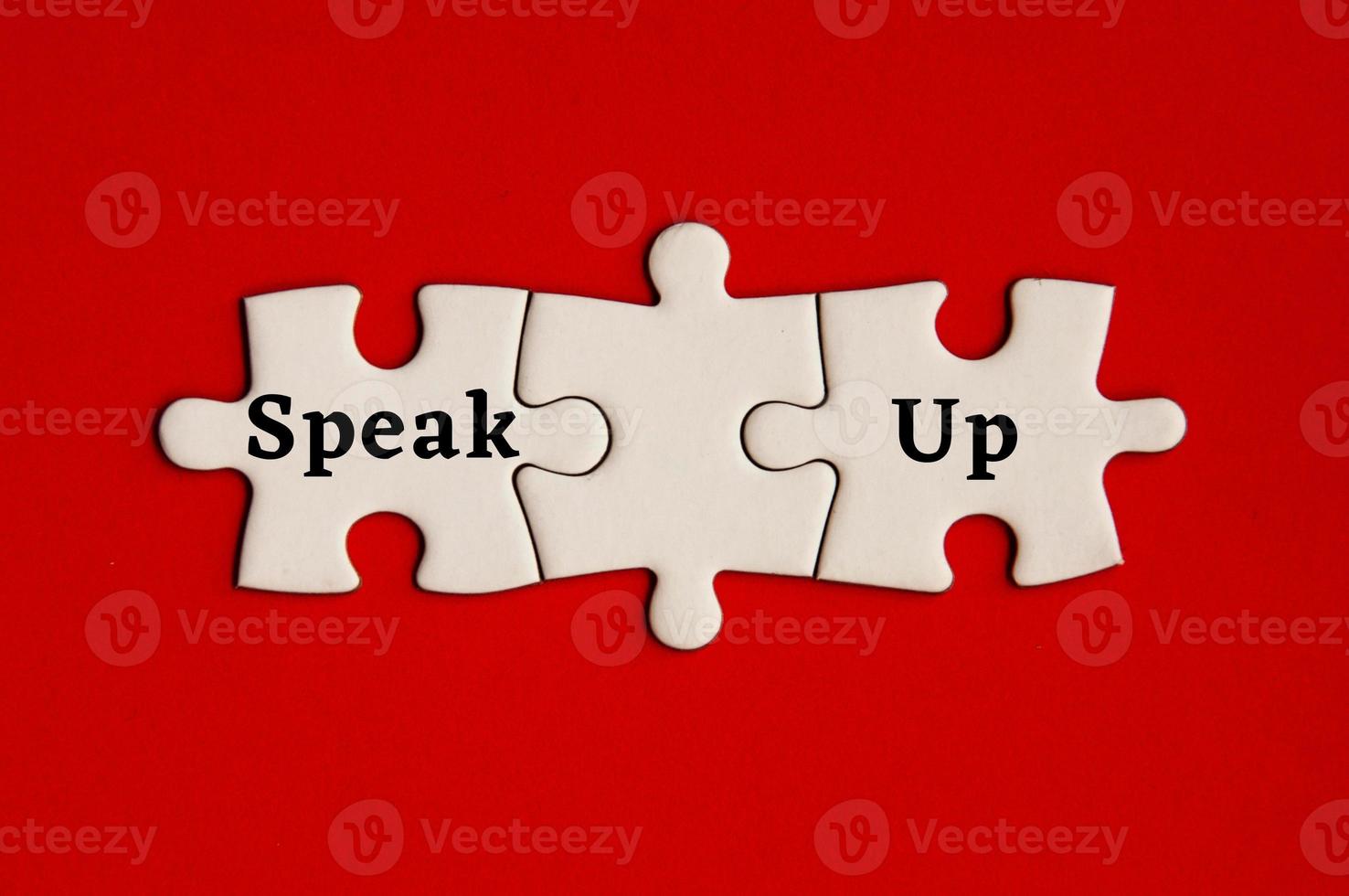 Text on missing jigsaw puzzle - Speak up. With red background. photo