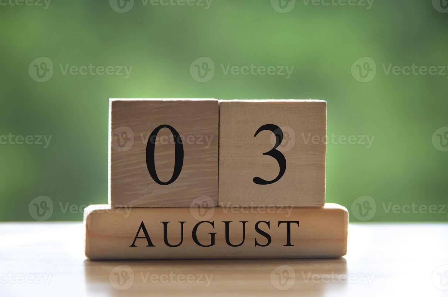 August 3 calendar date text on wooden blocks with blurred background park. Copy space and calendar concept photo