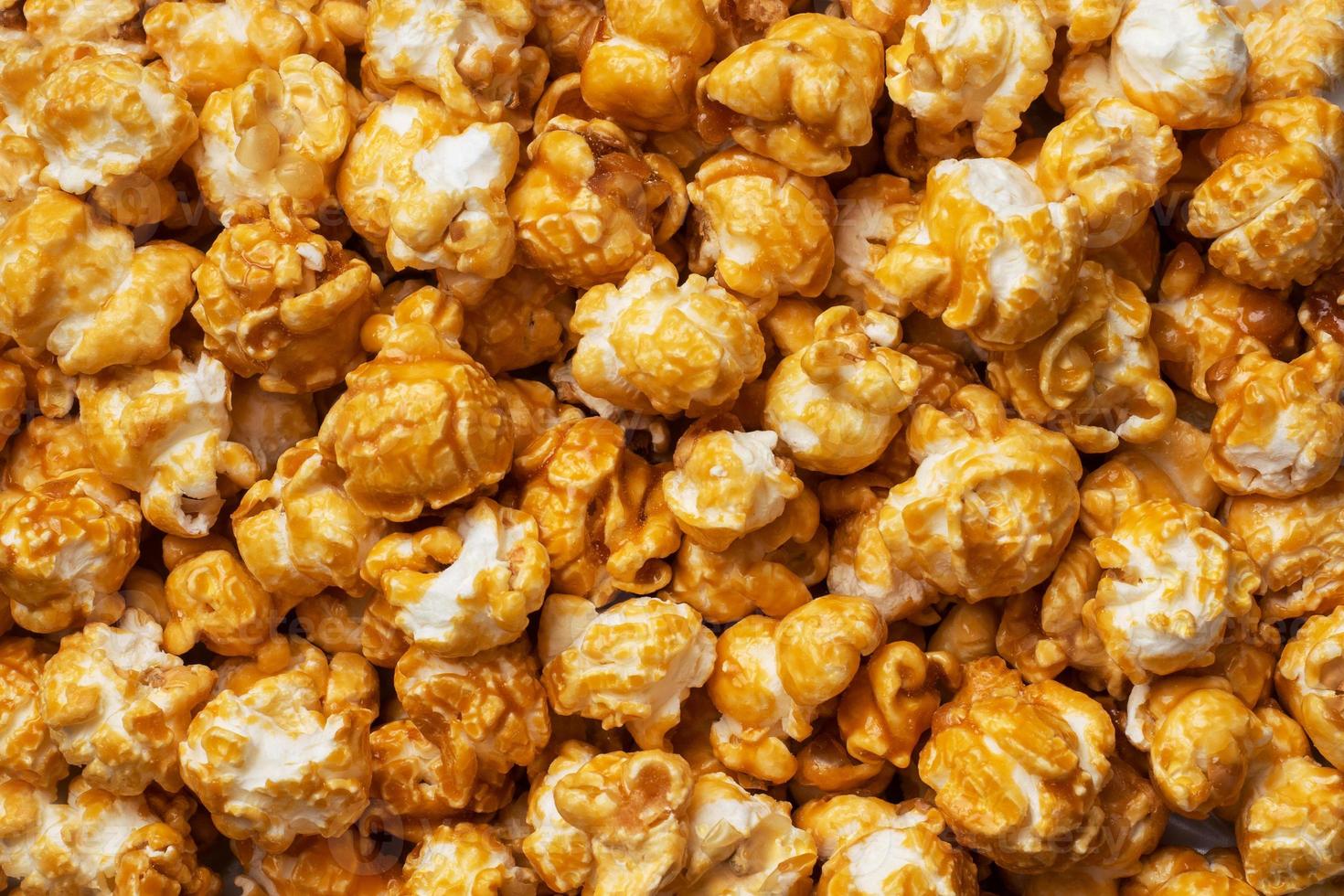 Background texture of popcorn in caramel glaze. Close up. photo