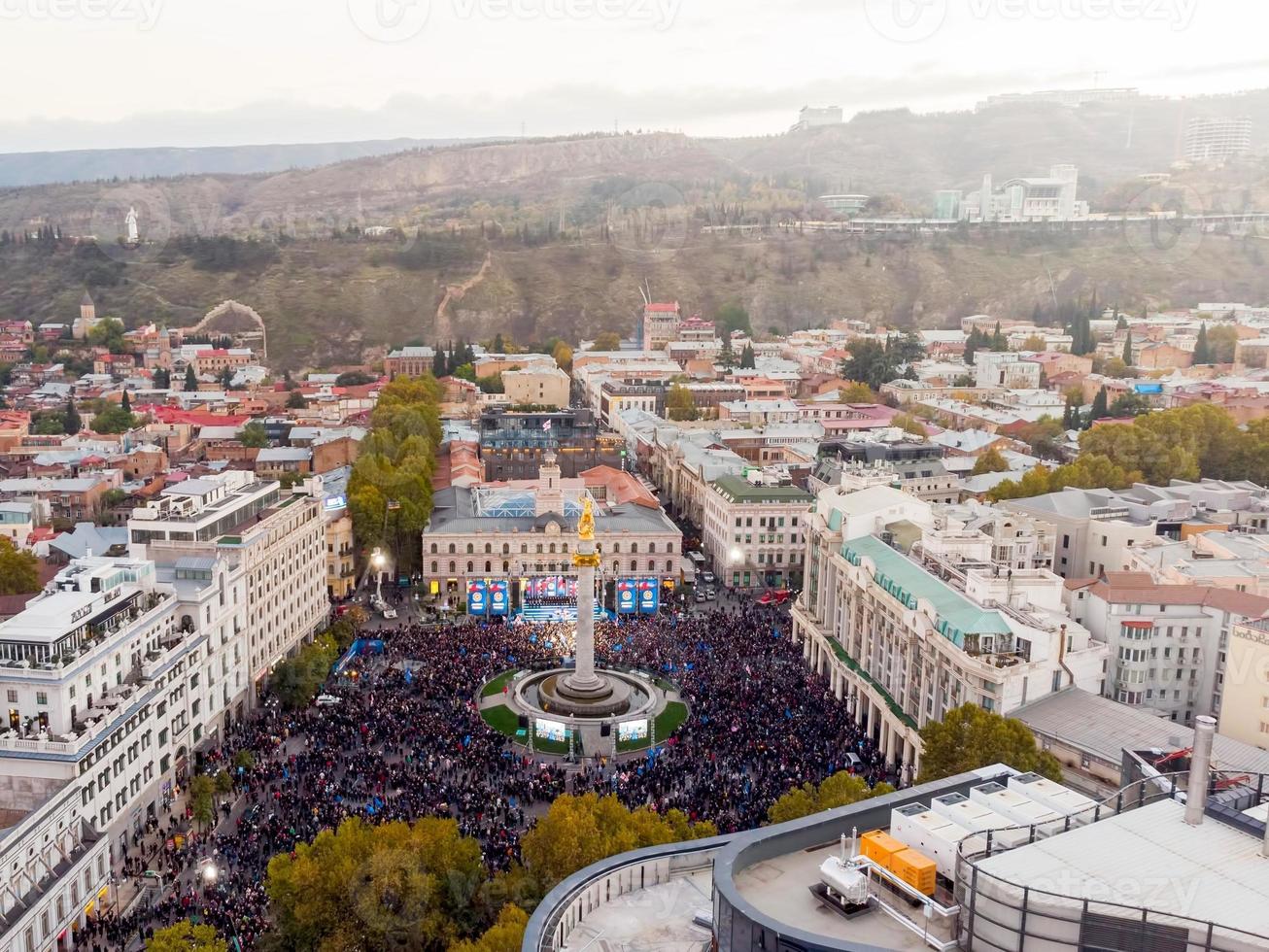 Tbilisi, Georgia - 28th october, 2021 - Drone view crowds of people in liberty square on democratic party Georgian dream political agitation event. Political powers in caucasus concept photo