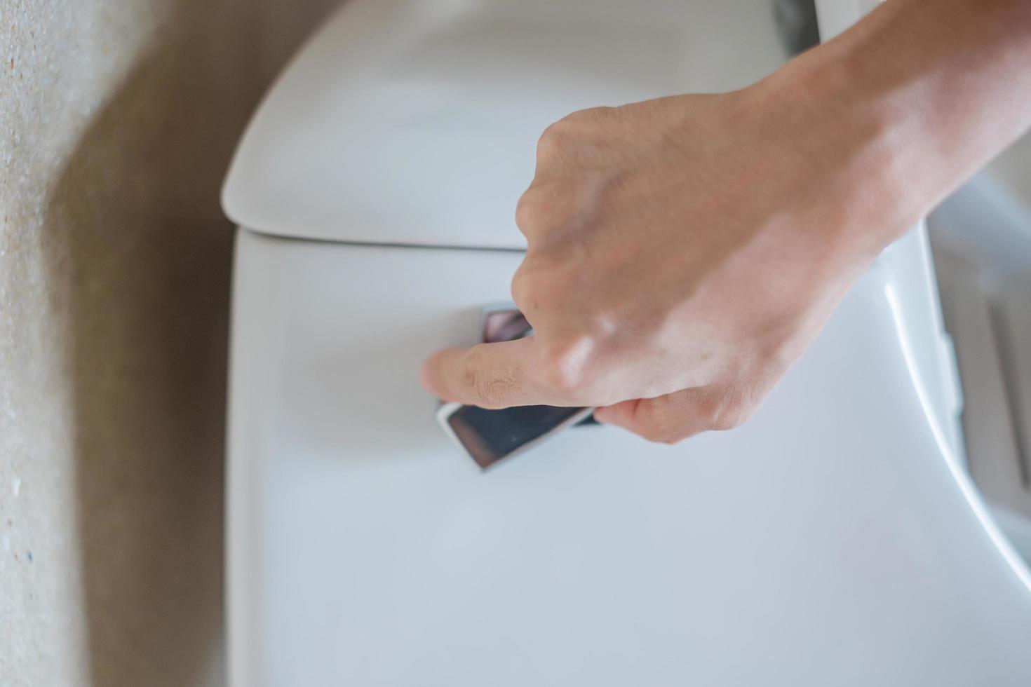 hand press and flush toilet. Cleaning, Lifestyle and personal hygiene concept photo