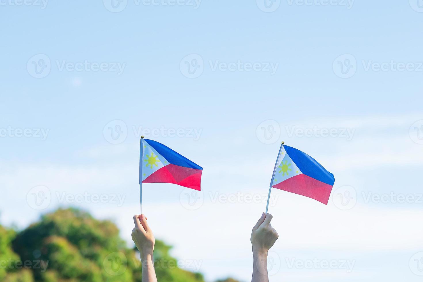 hand holding Philippines flag on nature background. 12th June of Independence day and happy celebration concepts photo