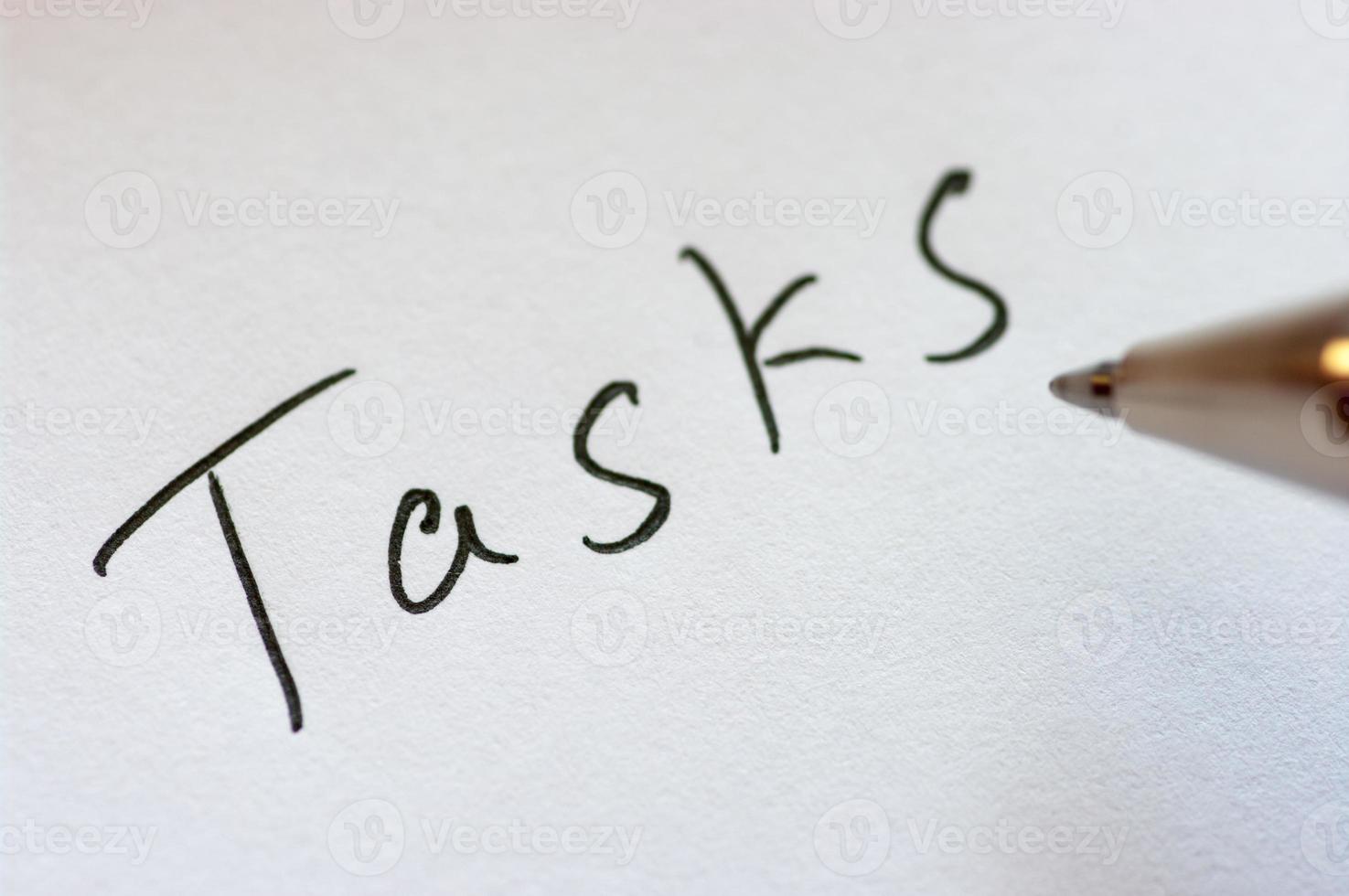 Close up image of handwritten word TASKS. photo