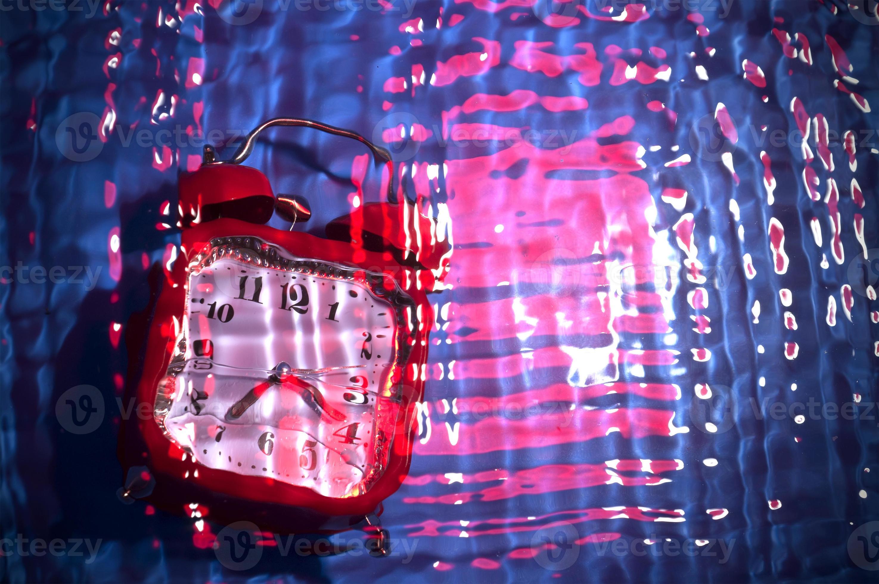 Abstract blurry background with a clock. Time concept in blue and pink