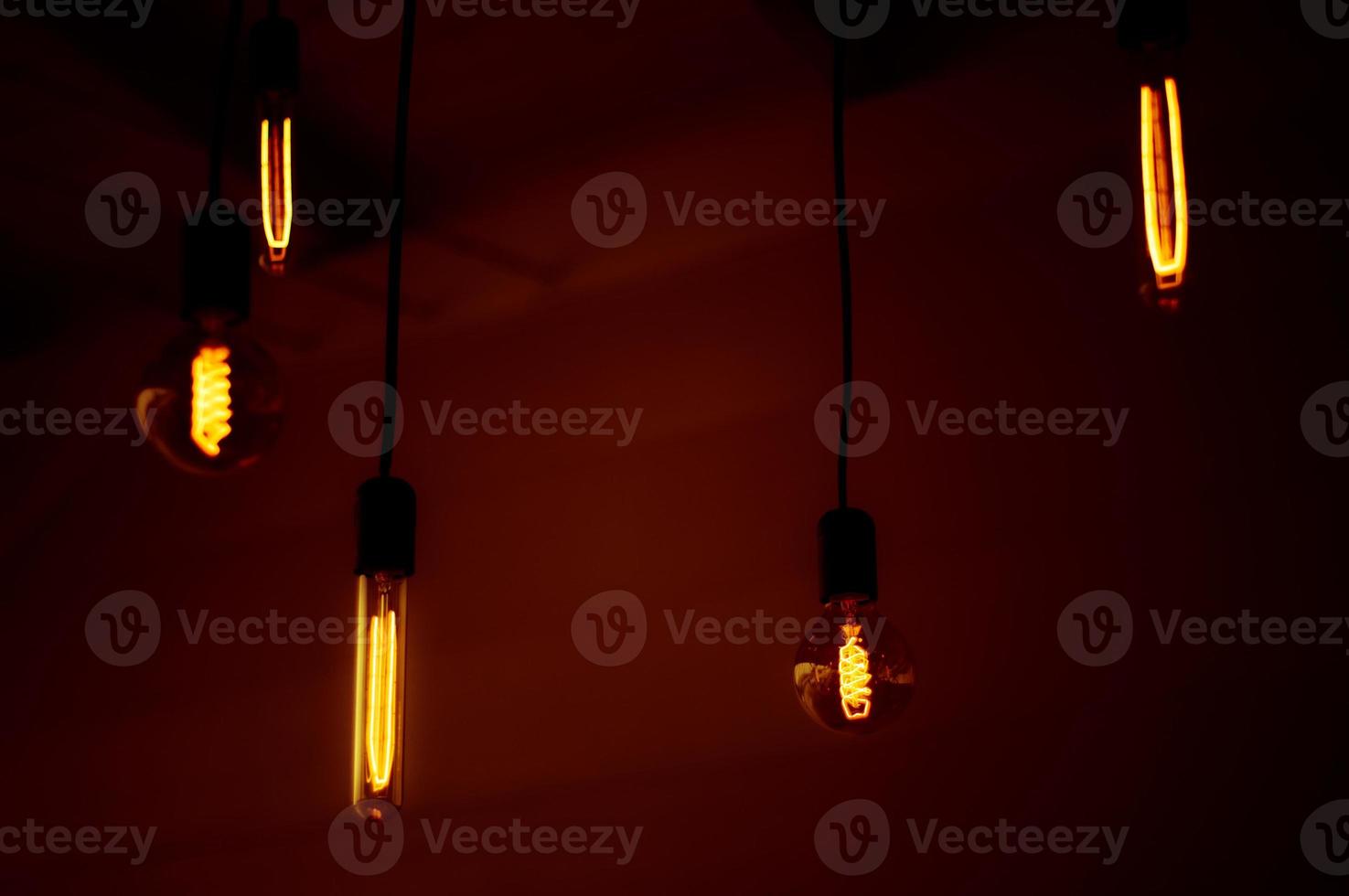 Group of tungsten light bulbs in the dark. photo