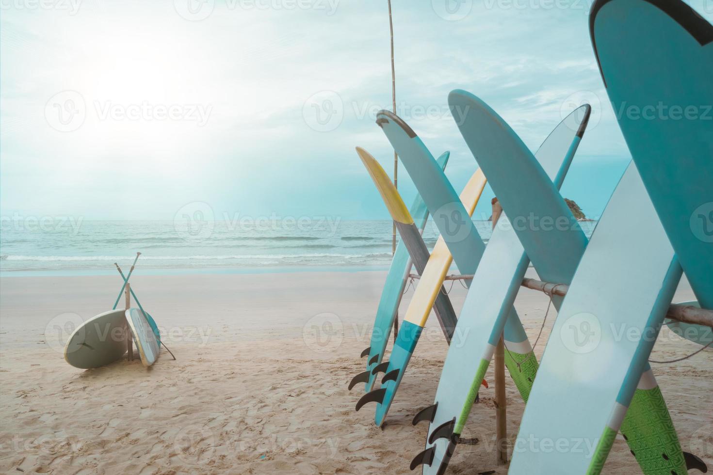 Many surfboards for rent  at summer beach with sunlight  blue sky. photo