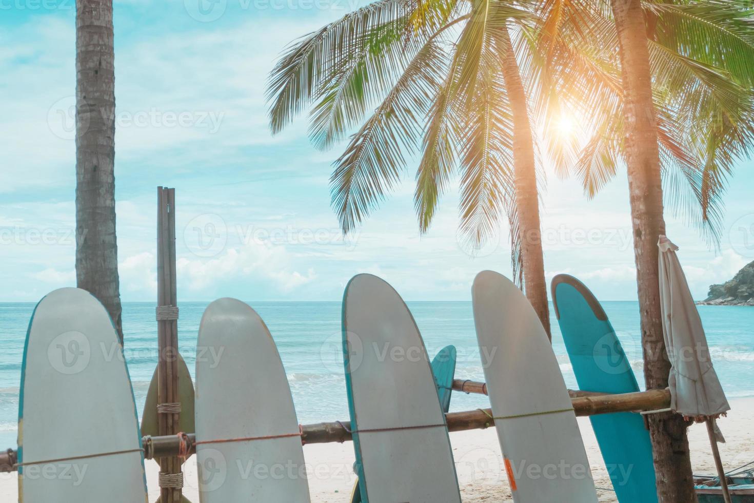 Many surfboards for rent  at summer beach with sunlight  blue sky. photo
