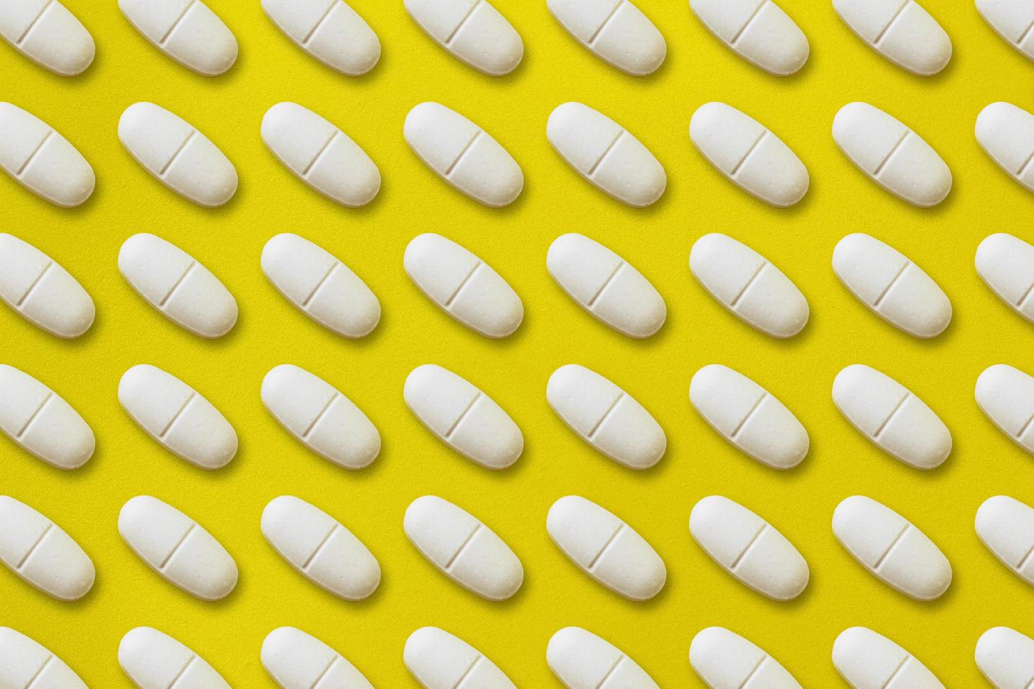Pattern medical capsules, tightly located on a yellow background. illustration. Medicine photo