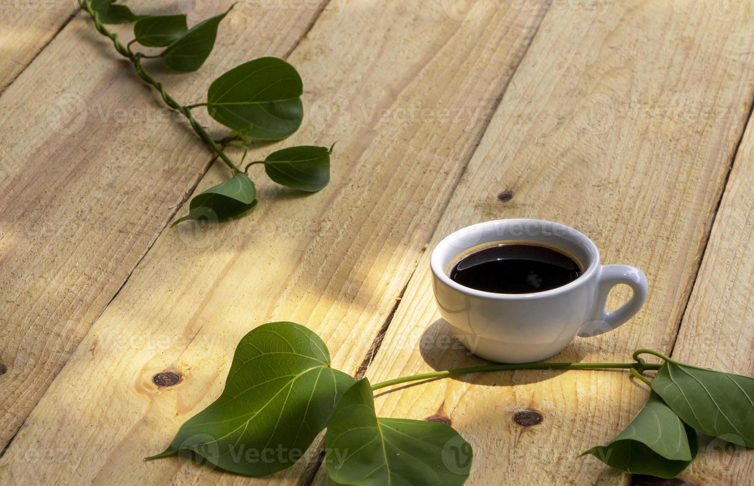 Cup of coffee on wooden planks. photo