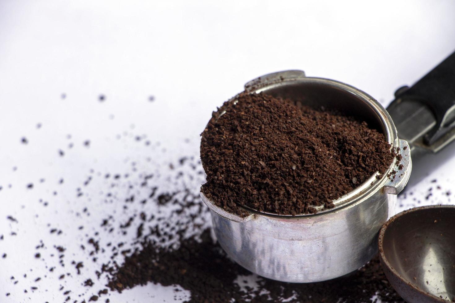 ground coffee in basket of portilter on table photo