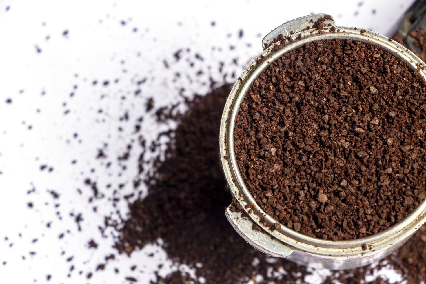 ground coffee in a basket of a portafilter, top view photo