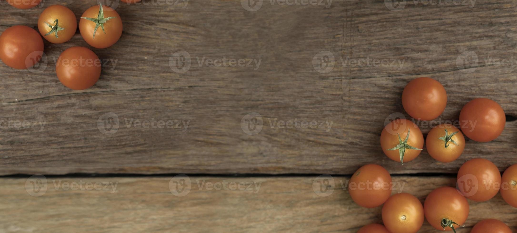Group tomato place on the wooden table use for background photo