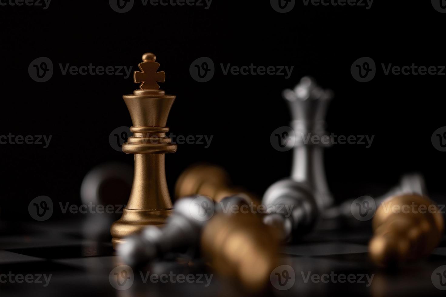 King and Queen standing in the midst of falling chess photo