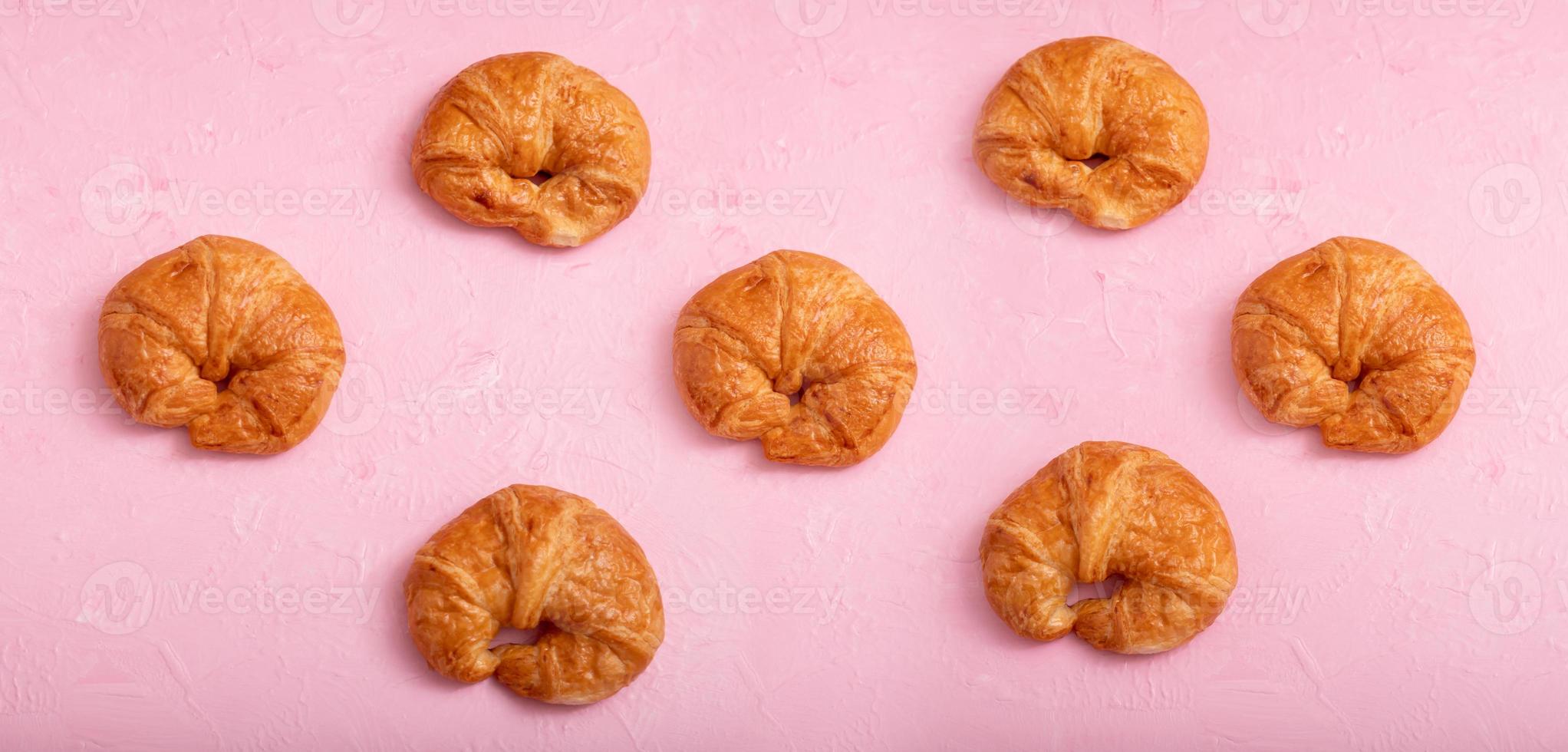 Croissant pattern on the pink background and texture photo