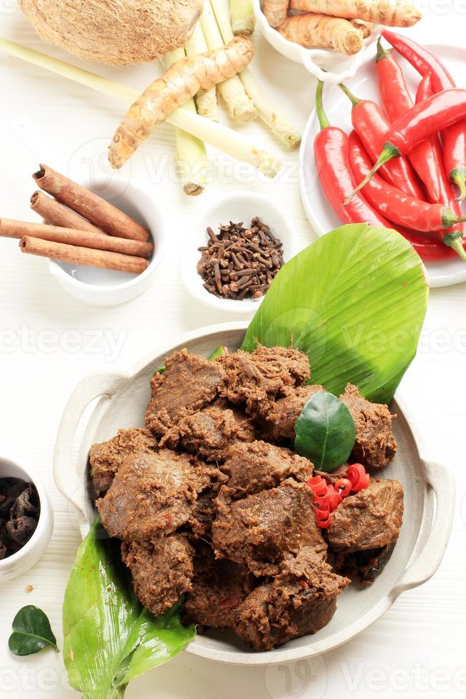 Rendang is an Indonesian West Sumatra Minangkabau Spicy Meat, Slow Cooked in Coconut Milk and Spices photo