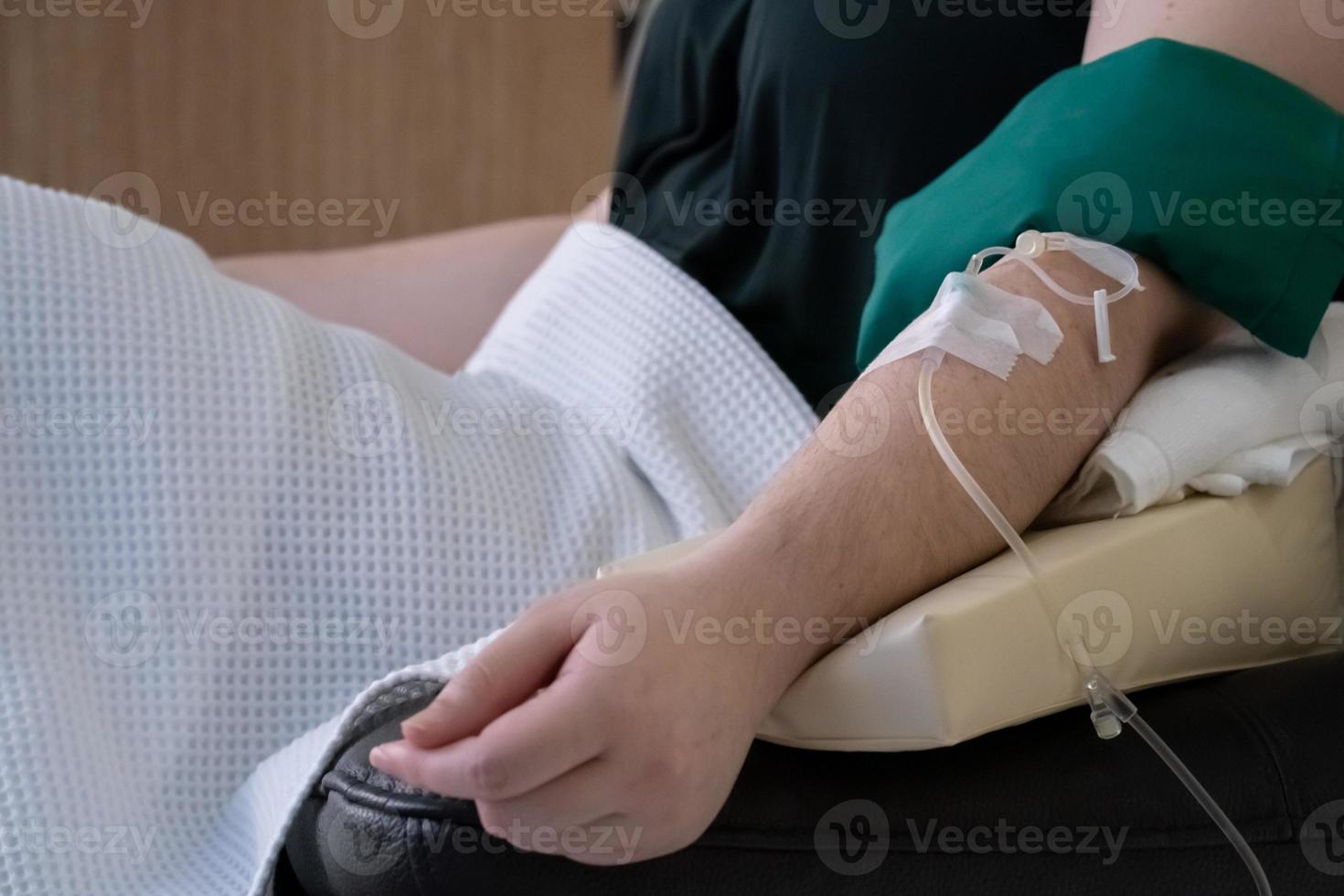 close up to Asian arm that receive vitamin from woman care clinic. photo