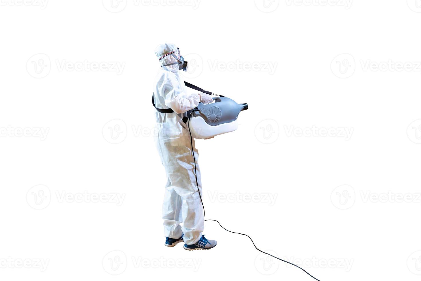 Professional technical man in prevention suit sprays sterilising solution by elctrical spray machine on wood floor and white background with stuido light. photo