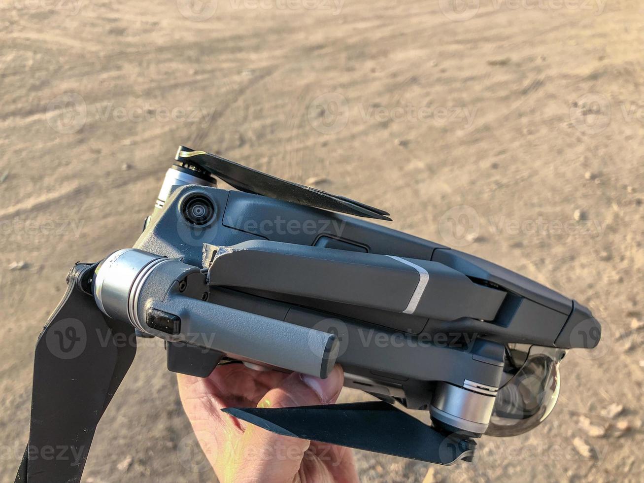 Failed drone crush on the tree and falled down with broken leg and scratched on it cover. photo
