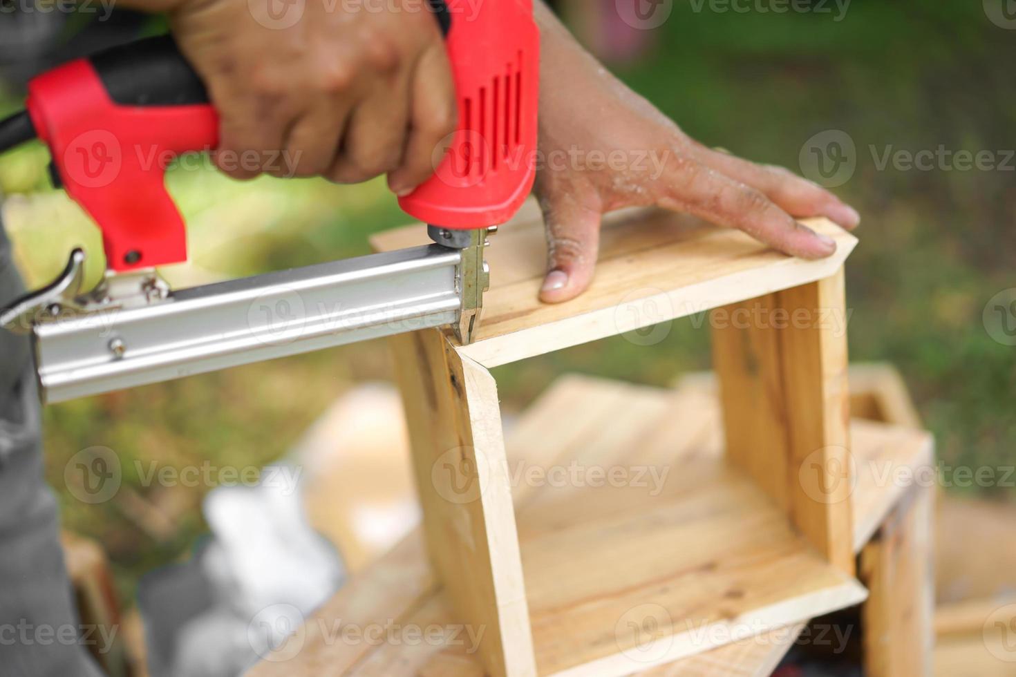 Asian carpenter are shooting Air Nailer photo