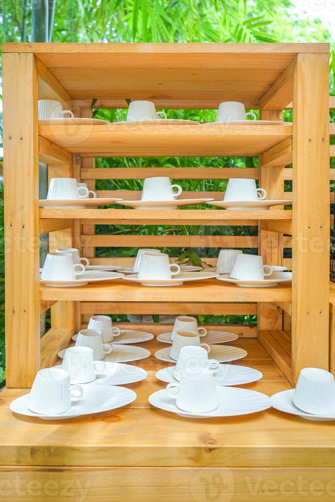 wood shelf in outdoor graden with a lot of coffee cup on it. photo