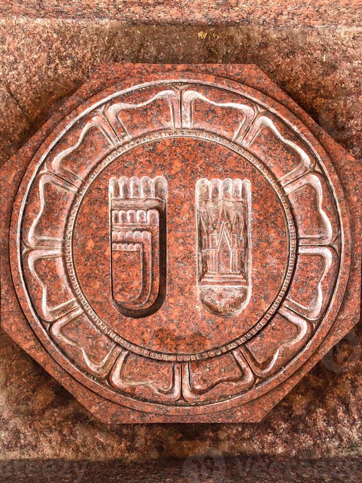 Octogon and circle Buddha footprint on the red brown stone at Thailand Temple. photo