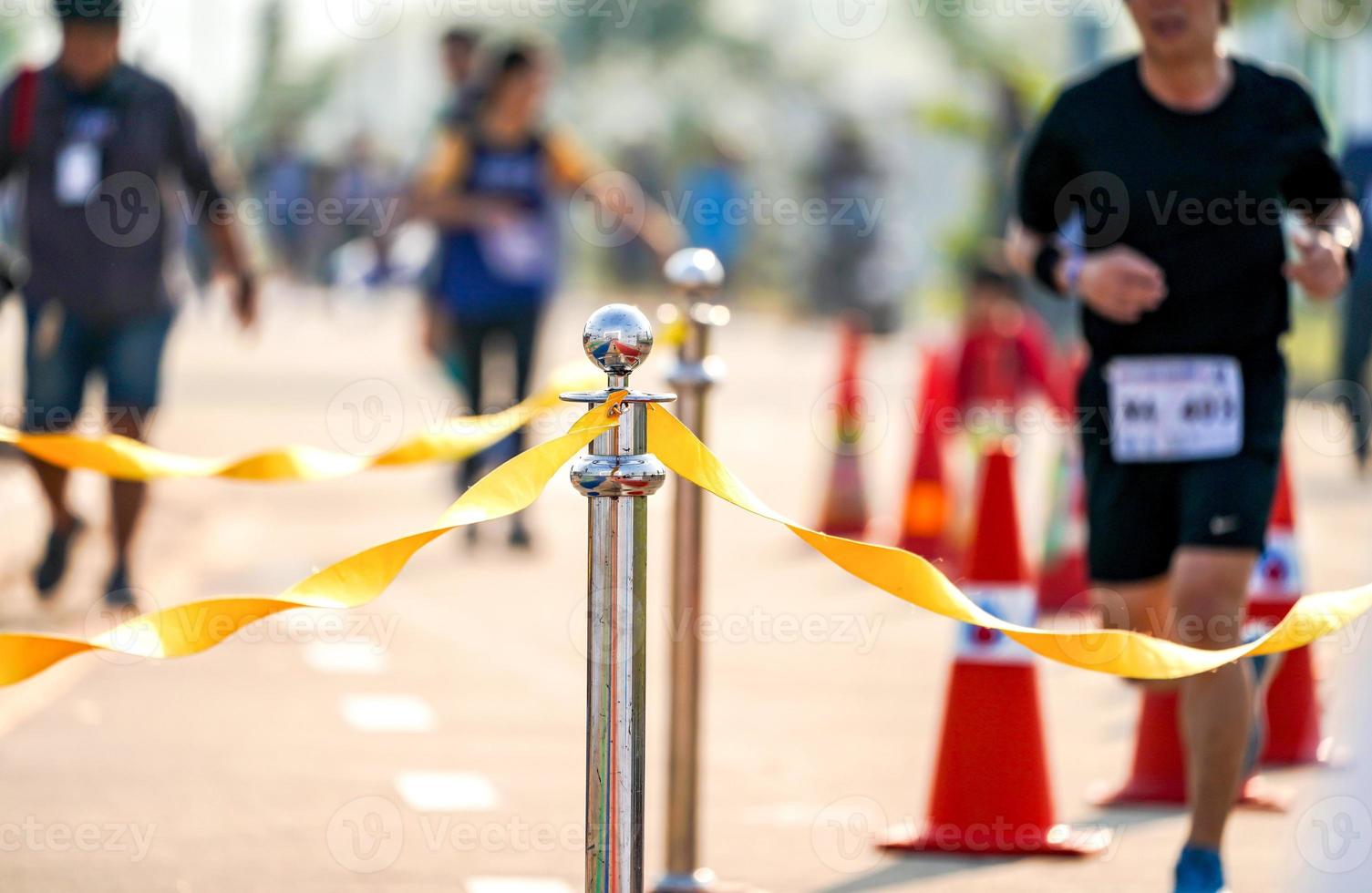 luxury stainless barricade with yellow rope ribbon on the road in Marathon event at the finish point. photo