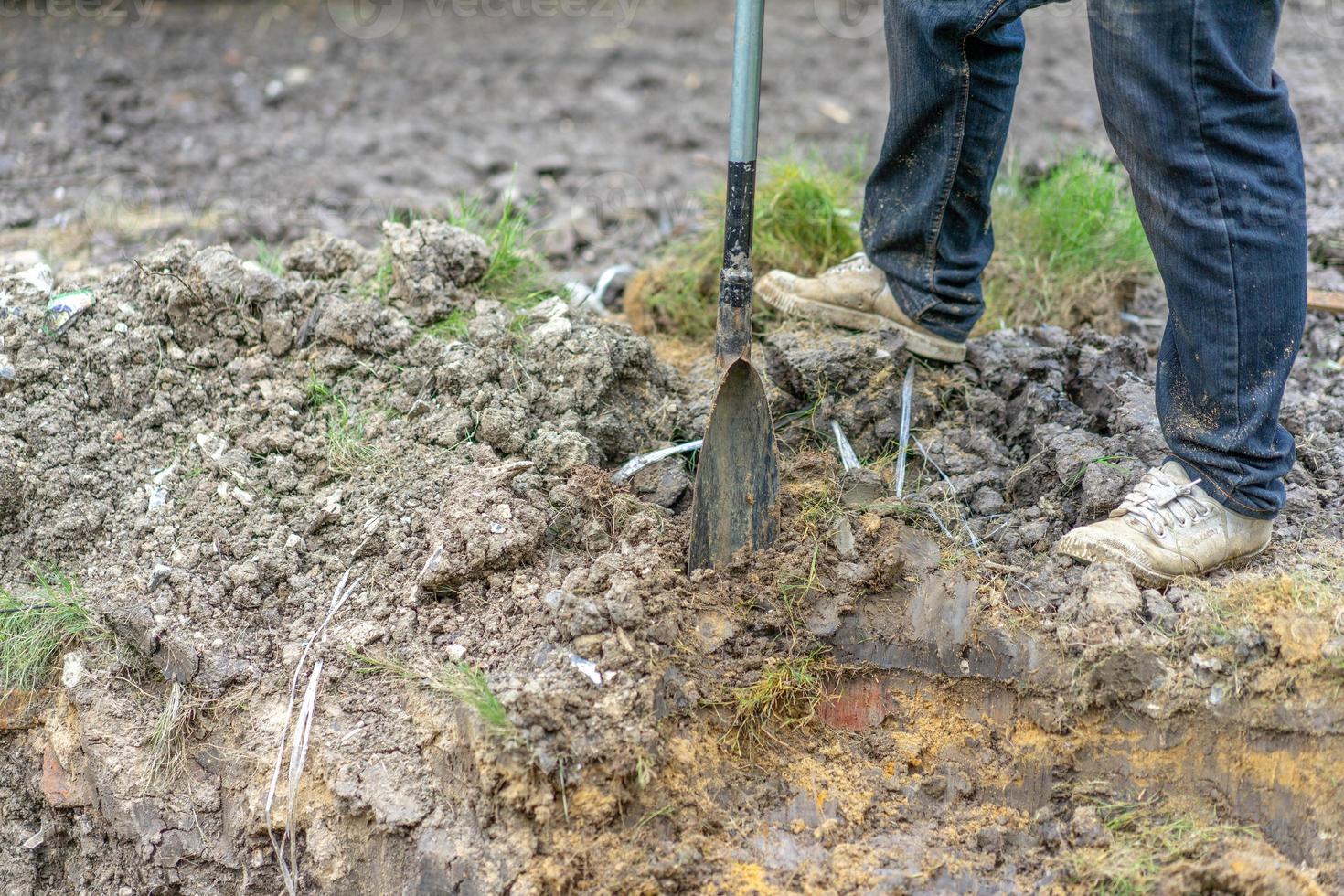gardener digs the soil with his equipment for gardening and prepare land for plantation. photo