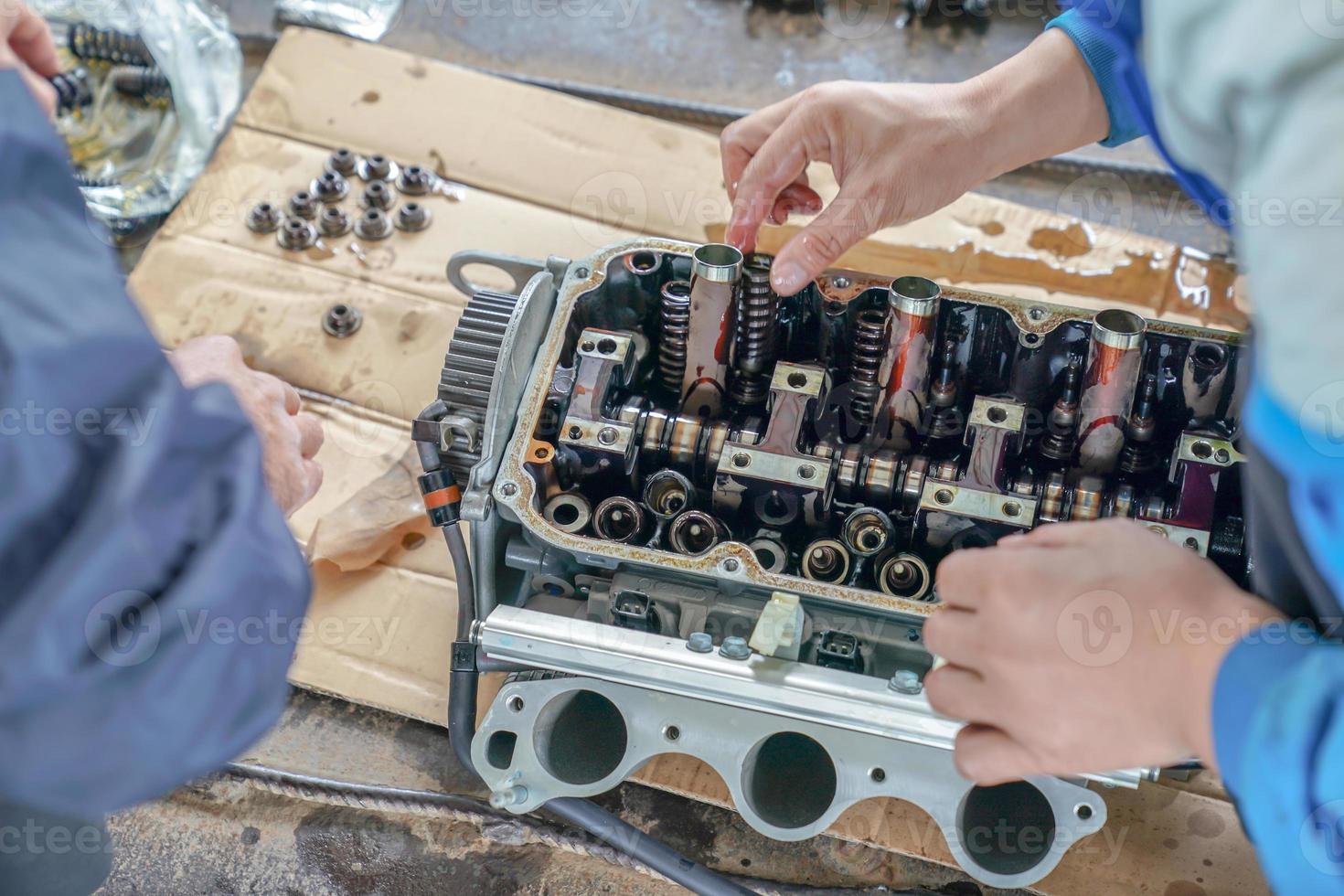 2 mechanic men try to fix and setup boat engine. photo