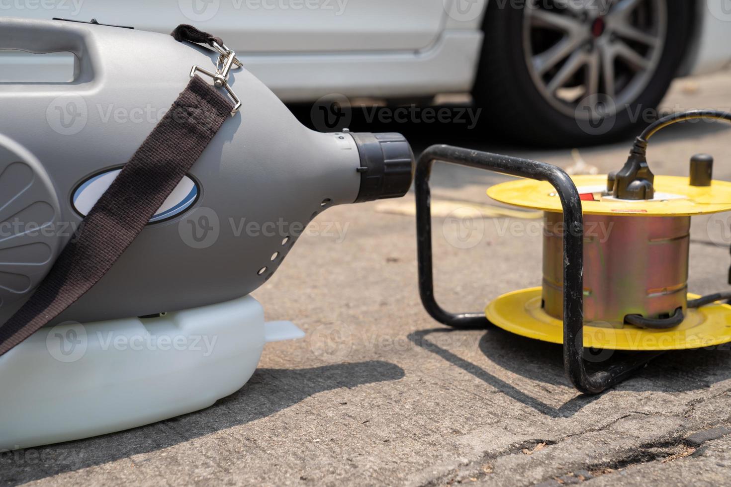 sterilizing machine water spray is standing in front of personal vehicles and ready to use for kill and protect the coronavirus COVID19. photo