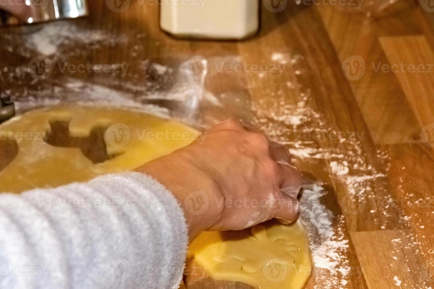 Person baking decorative Christmas cookies photo