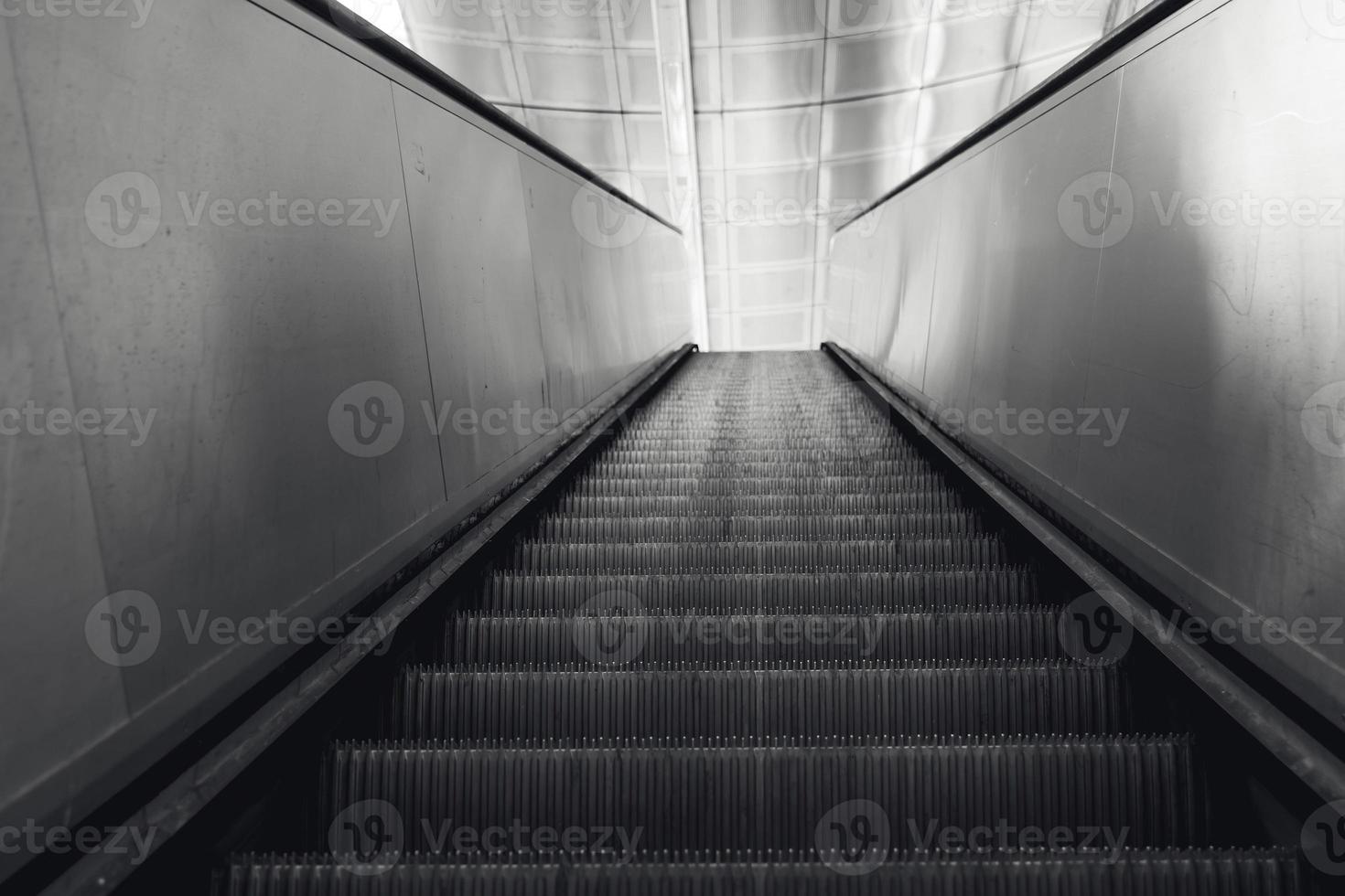 escalator in black and white shot photo