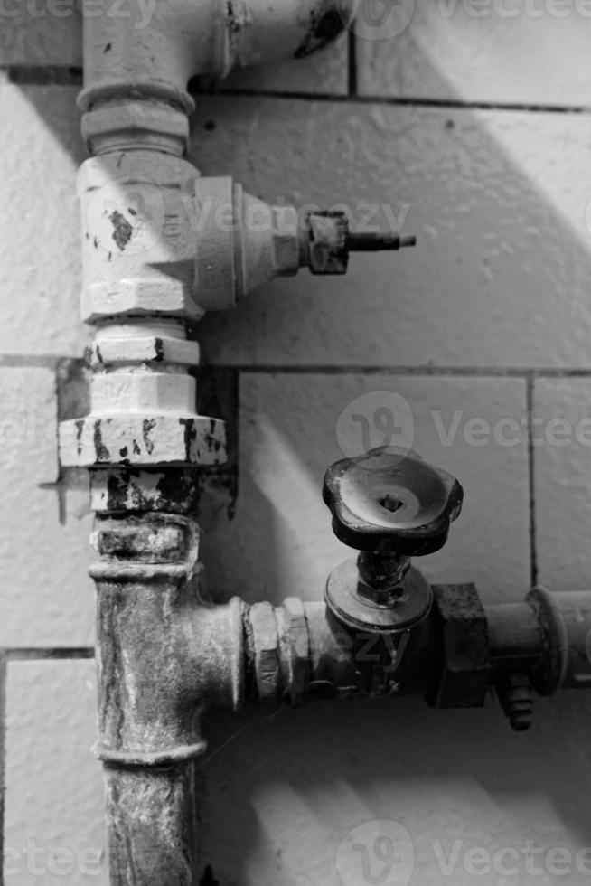 Flow control valve on old corroded water pipes photo