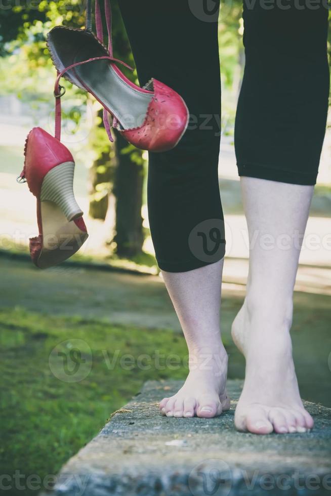 Woman walking barefoot on a wall photo