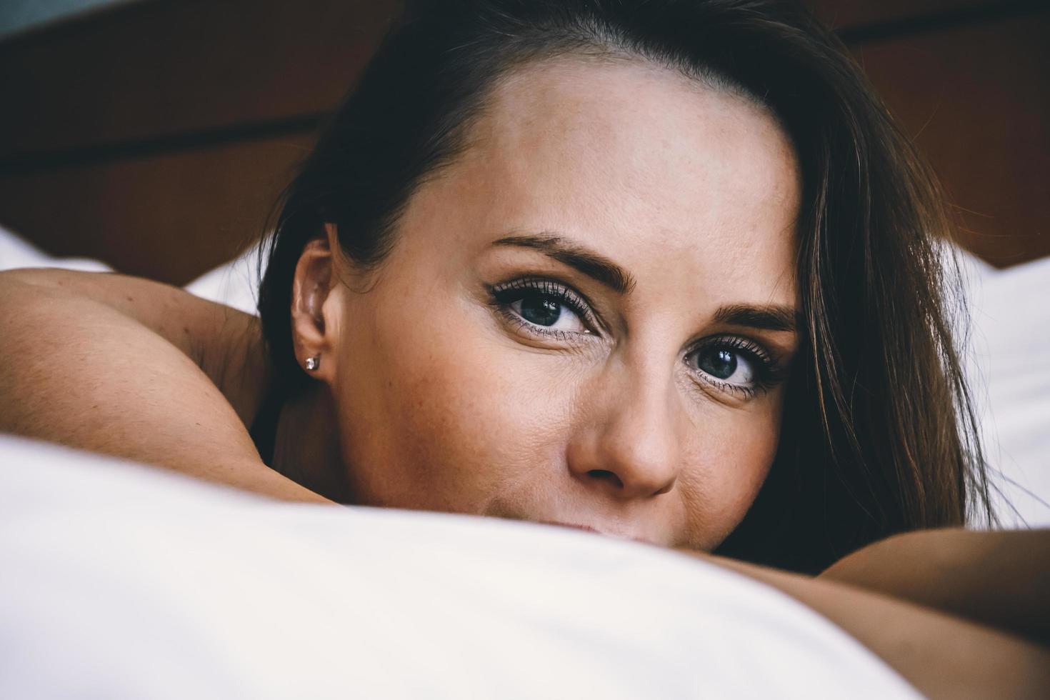 retrato de una mujer joven en la cama foto