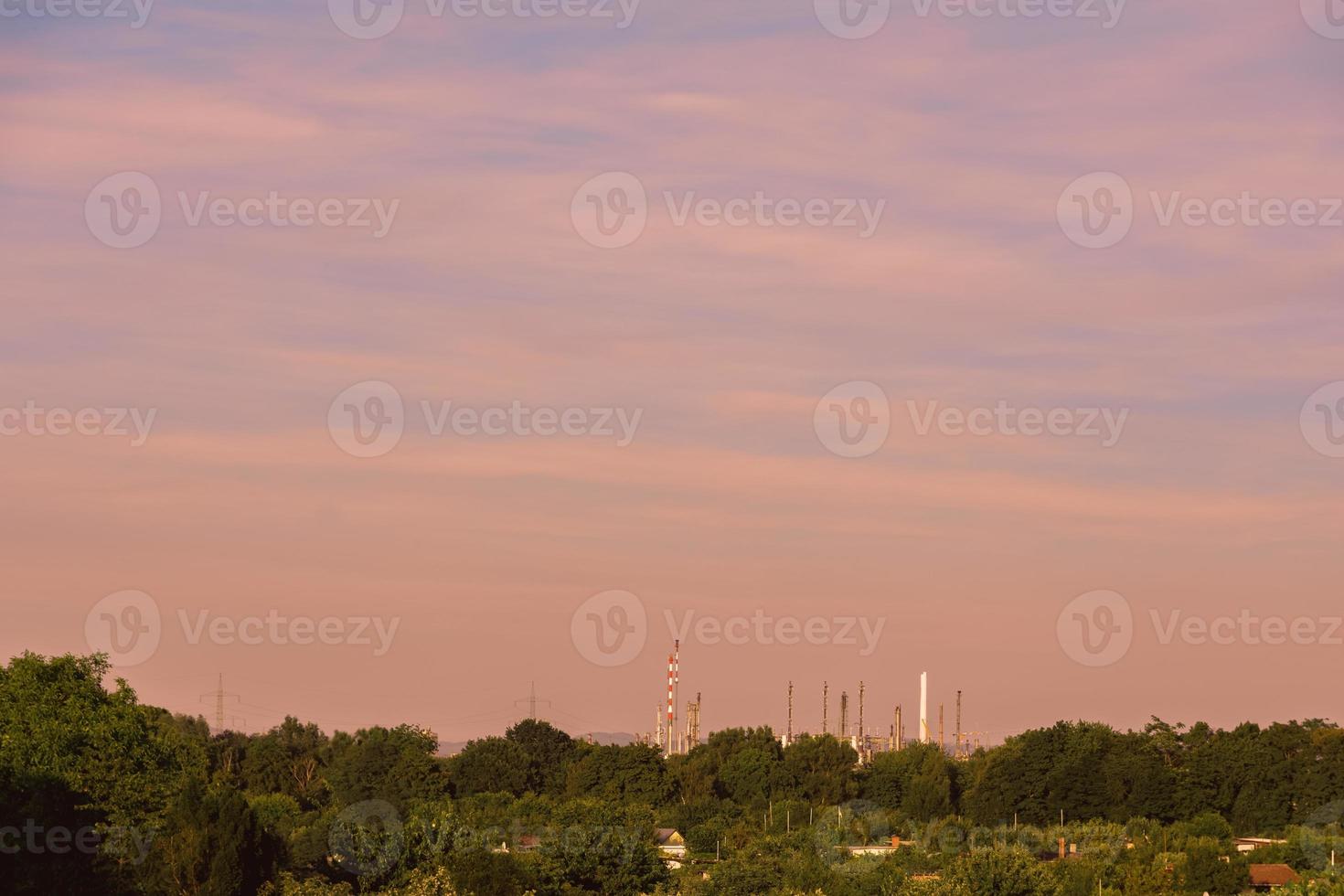 a sunset over an industrial area photo