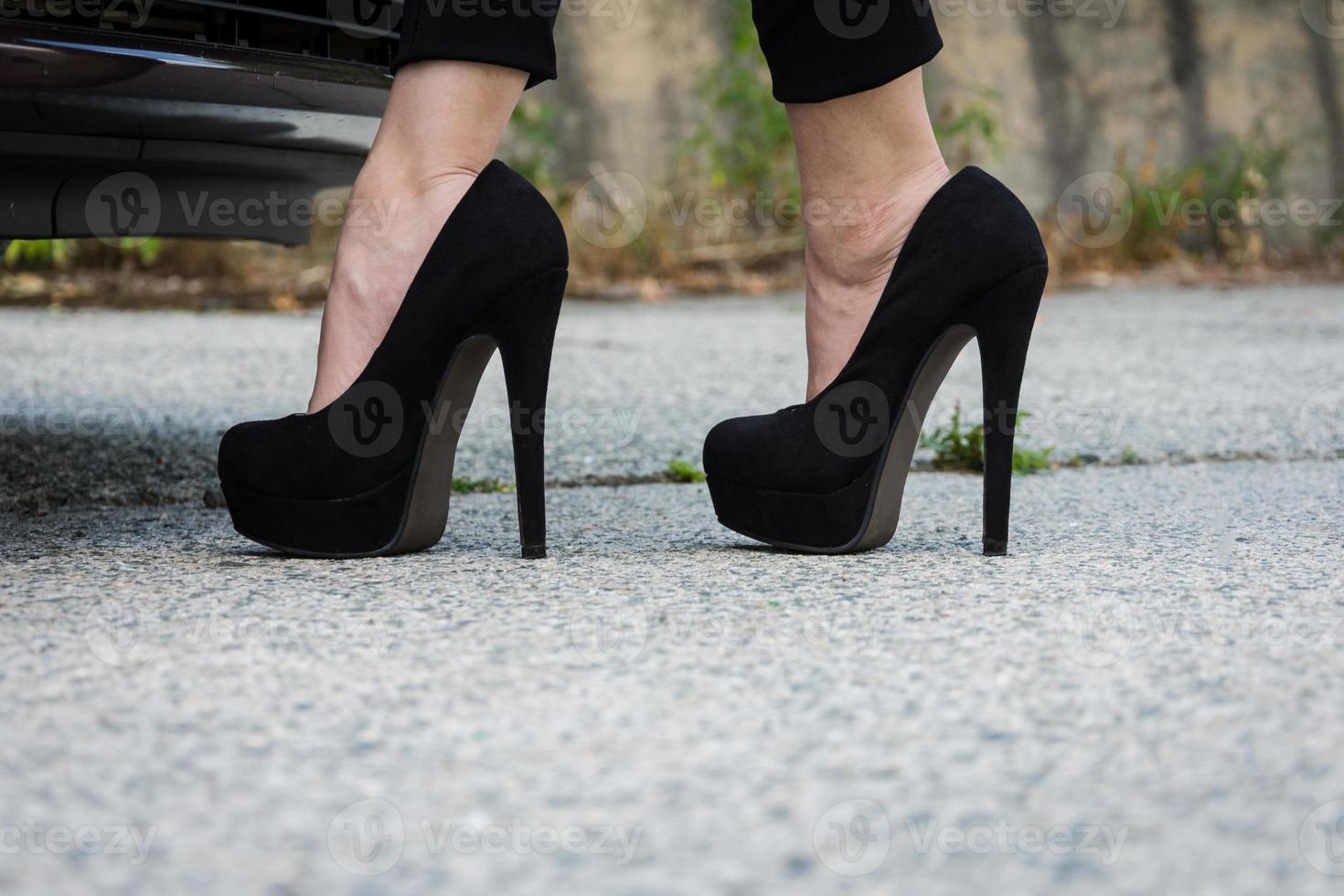 Woman legs with black high heels photo